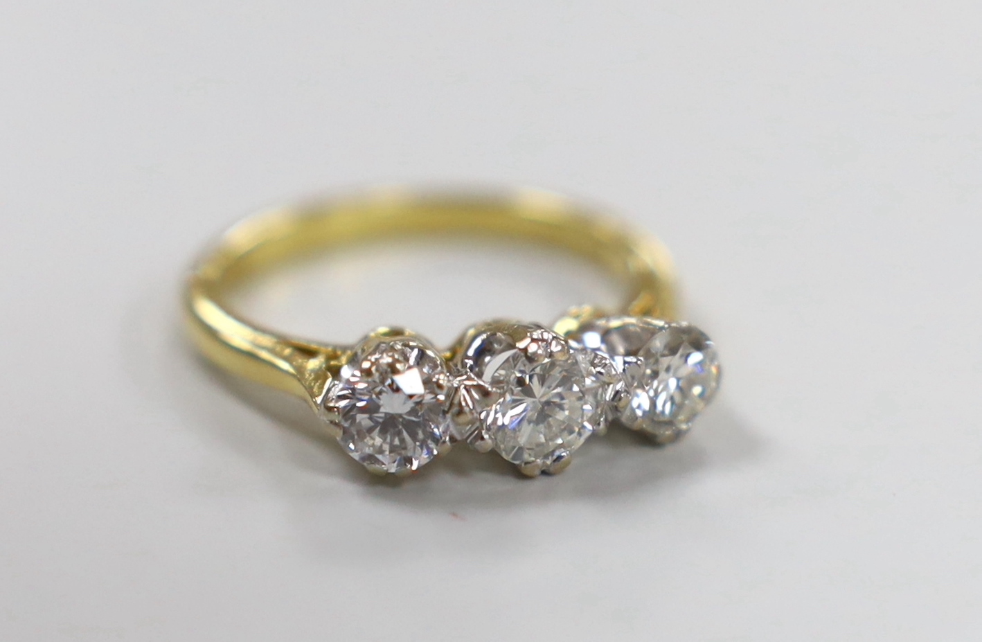 A 1970's 18ct gold and three stone diamond set ring, size O/P, gross weight 4.7 grams